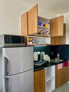 a kitchen with a refrigerator and a microwave at T-Homes in Nairobi