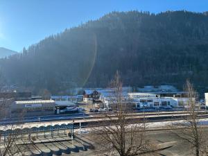 a train yard with a train station with trains at LYMA Suites - Apartment B44 in Immenstadt im Allgäu