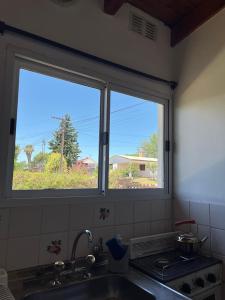 a kitchen with a window over a sink and a sink at Departamento de las sierras in Embalse