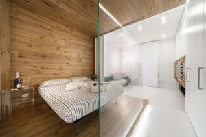 a bedroom with a bed and a wooden wall at B&B Portorosso in Monopoli
