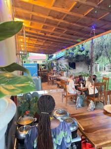a group of people sitting at tables in a restaurant at Sophie Homestay in Moshi