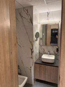 a bathroom with a sink and a mirror at Luna Stays in Greater Noida +5 photos