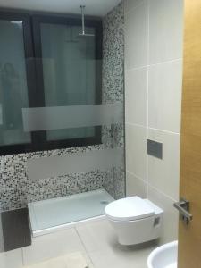a bathroom with a toilet and a sink at Portugal Alma - Oporto Guesthouse in Ermesinde +42 photos