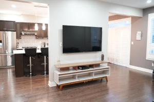 a living room with a flat screen tv on a wall at Luxury 5BR Home with Spa Bath in Burlington