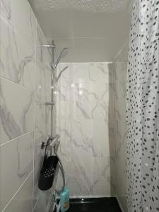 a bathroom with a shower with a black sink at Flat ADB in Maintenon