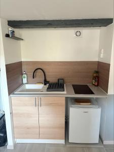 a small kitchen with a sink and a stove at Flat ADB in Maintenon