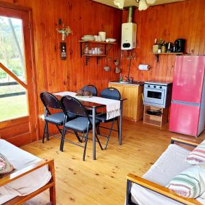 eine Küche mit Tisch und Stühlen in einem Zimmer in der Unterkunft Chiloe Profundo in Chonchi