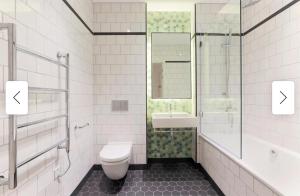 a bathroom with a toilet and a sink at Cozy and Spacious Central London room in Canary Wharf Flat with a City View & a Private Bathroom in London +22 photos