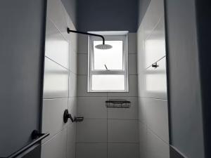 a bathroom with a shower and a window at Evangeline House in Cape Town