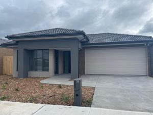 a house with a garage and a building at Northern Retreat in Wallan