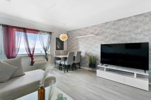 a living room with a large flat screen tv at Centrum apartment 1 in Ålesund
