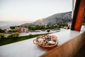 a bowl of shells sitting on a window sill at Panoramic View Villa in Stagiates