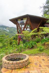 a brick fire pit in front of a house at Glamping Corazón del Molino in Ubaque