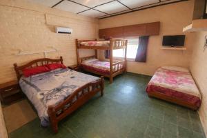 a bedroom with two bunk beds and a television at Apartamentos Quintana in Santa María