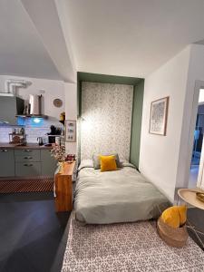 a bedroom with a bed and a kitchen at LA CASETTA TRA i LAGHI in Omegna