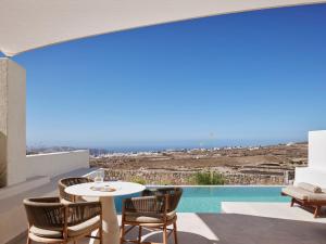 a patio with a table and chairs and a pool at Ark in Pyrgos