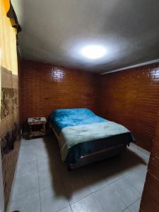 a bedroom with a bed in a brick wall at Alojamiento en Tlaxco in Tlaxco de Morelos
