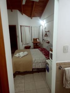 a bedroom with a bed with two towels on it at Suites Piltri in El Bolsón