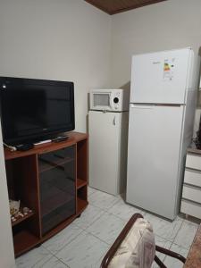 a living room with a refrigerator and a tv at Alojamiento Fiara in Chajarí