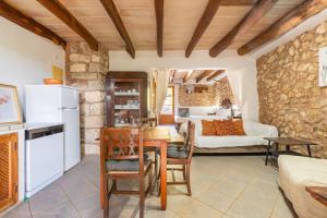 a kitchen and living room with a table and chairs at Agroturismo Sa Vall by MHR in Son Macia