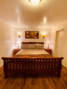 a bedroom with a large bed with two lamps at PAYSON INN & Suites in Payson +3 photos