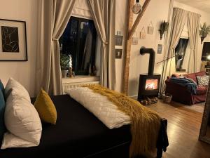 a living room with a bed with a blanket on it at Boutique Apartment Benz 2 in Bergisch Gladbach