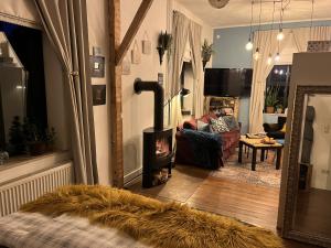 a living room with a wood stove in a living room at Boutique Apartment Benz 2 in Bergisch Gladbach +25 photos