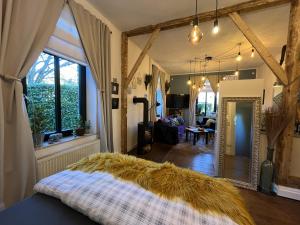 a bedroom with a bed and a living room at Boutique Apartment Benz 2 in Bergisch Gladbach