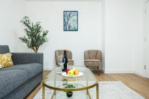 a living room with a couch and a glass table at West London Spacious Modern House Garden Driveway in London