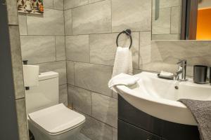 a bathroom with a white sink and a toilet at Studio Close To Alhambra And Bradford Live Walk To Stations in Bradford