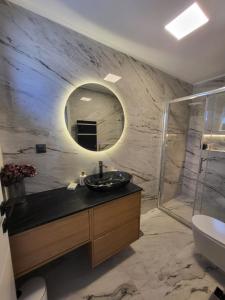 a bathroom with a sink and a mirror at Apartments Aldo in Cavtat