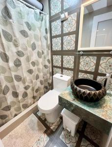 a bathroom with a toilet and a sink and a mirror at Casa Cerezos in Ica +21 photos