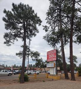 a sign for a gas station in a parking lot at PAYSON INN & Suites in Payson