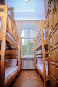 two bunk beds in a room with a window at Golden Globus Hostel in Kyiv