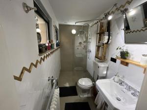 a white bathroom with a sink and a toilet at Boutique Apartment Benz 3 in Bergisch Gladbach +26 photos