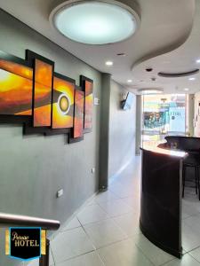 a lobby with paintings on the wall in a restaurant at Paraíso Hotel Ubaté in Ubaté