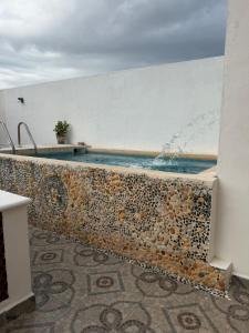 a swimming pool on top of a wall with the ocean at Casa Aleymar in Playa del Carmen