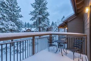 a balcony with two chairs and a table in the snow at Bright 3BR Condo Near Northstar in Truckee