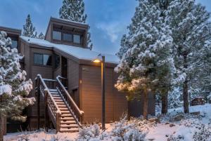 a house in the snow with trees and a staircase at Bright 3BR Condo Near Northstar in Truckee