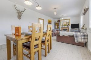 a dining room and living room with a table and chairs at 3 Bed in Forden oc-c30173 in Forden