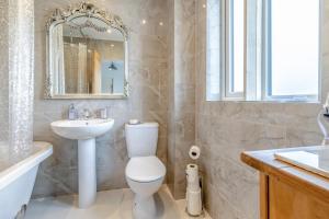 a bathroom with a toilet and a sink and a mirror at 3 Bed in Forden oc-c30173 in Forden +18 photos
