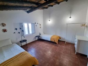 a bedroom with a bed and a desk in it at Refúgio de Monsaraz in Monsaraz