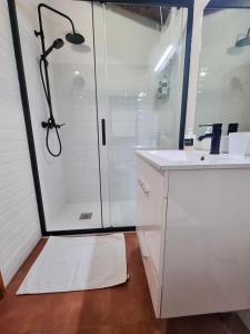 a white bathroom with a shower and a white sink at Refúgio de Monsaraz in Monsaraz +31 photos