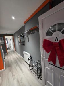 a room with a door with a red bow on it at Cozy Garden Apt - 8ight Havens in Folkestone