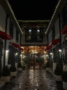 a building with a walkway with lights on it at Hani i Gjelit Hotel, Korce in Korçë
