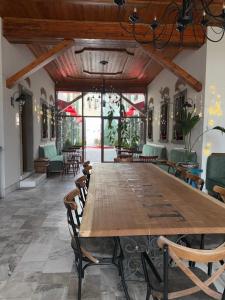 a large wooden table in a room with chairs at Hani i Gjelit Hotel, Korce in Korçë