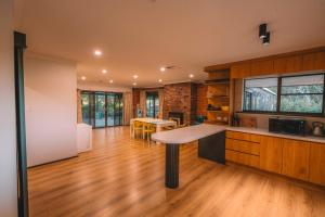 a kitchen with a table in the middle of a room at Vineyard Retreat in the Heart of McLaren Vale in McLaren Vale