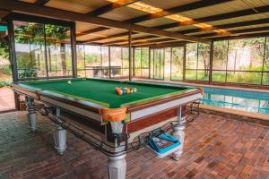 a pool table on a brick patio next to a swimming pool at Vineyard Retreat in the Heart of McLaren Vale in McLaren Vale