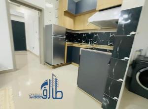 a kitchen with stainless steel appliances in a room at Studio SAHRAOUI in Nouakchott