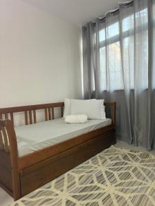 a bed sitting in a room with a window at Eco House1 in Santos